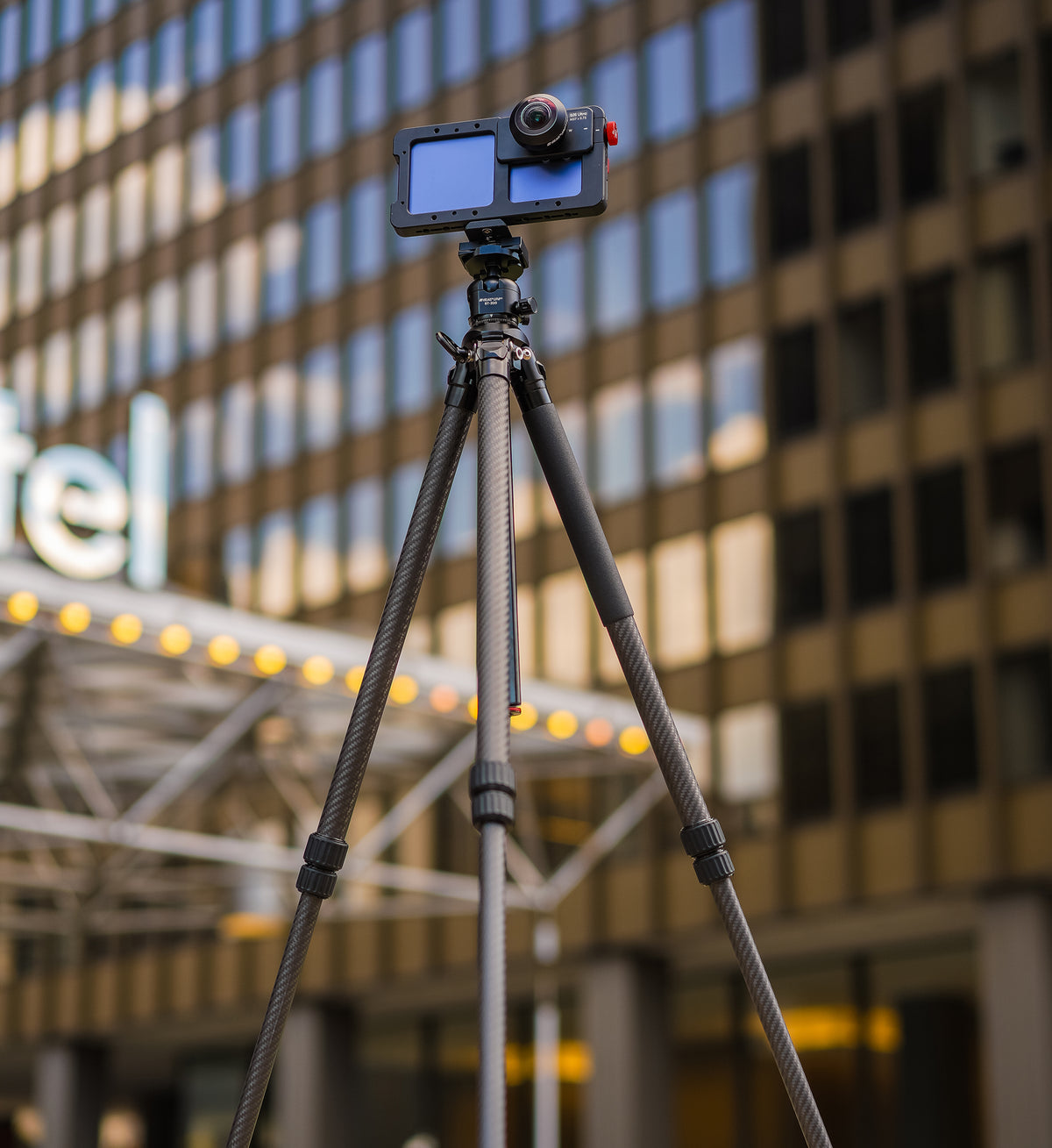 Beastgrip BT-200 carbon fiber tripod supporting a Samsung Galaxy smartphone in a Beastcage with an external fisheye lens for mobile photography and filmmaking.
