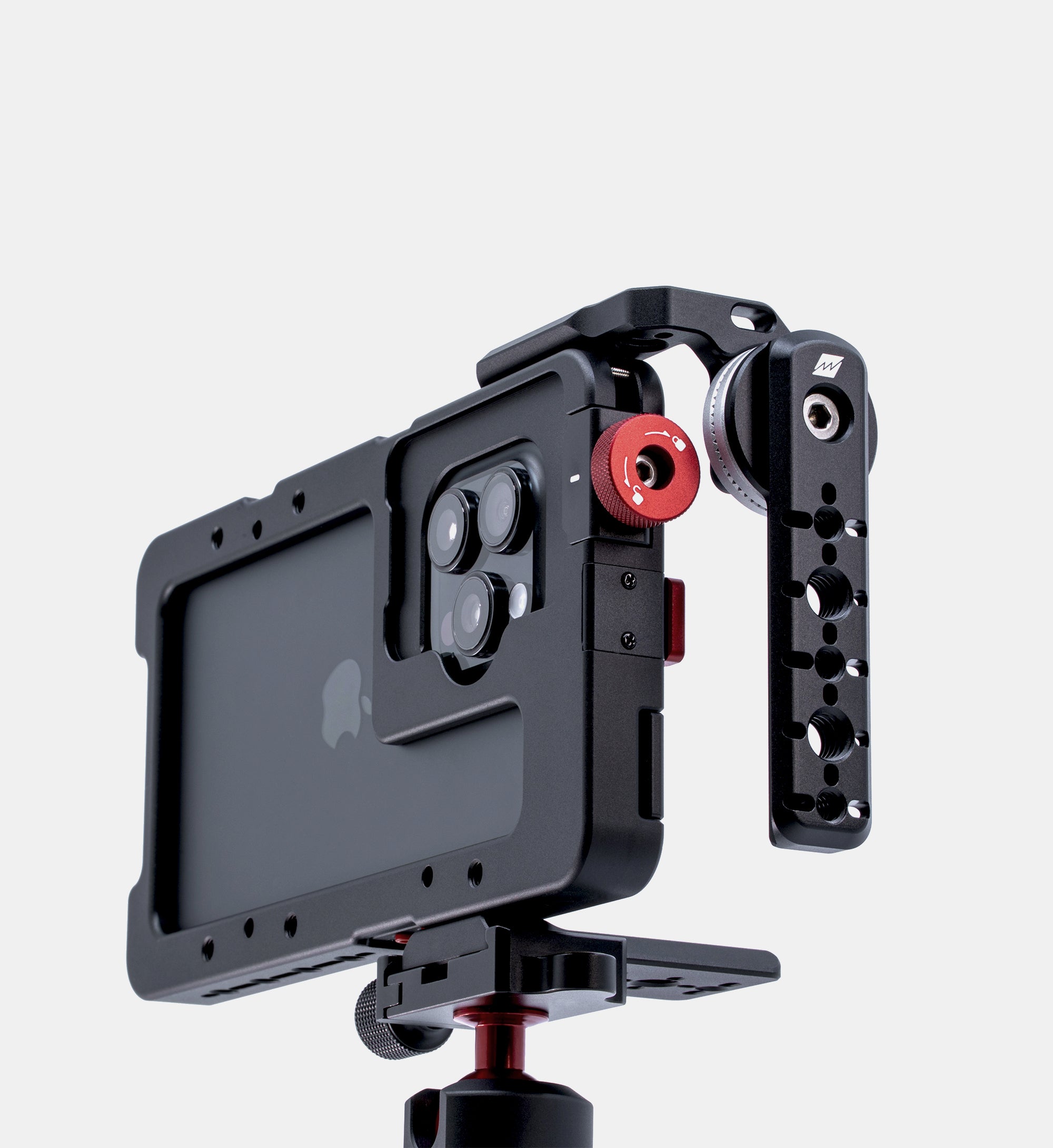 Beastgrip LT Mount attached to left side of Beastcage 16 Pro Max, shown in studio setup on compact tripod — modular side handle mount for iPhone video rigs.