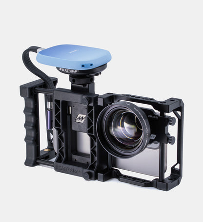 Studio view of Beastgrip Pro iPhone camera rig with MagSafe Magnetic Mount holding a SanDisk SSD drive and Beastgrip 1.7X Telephoto Lens attached