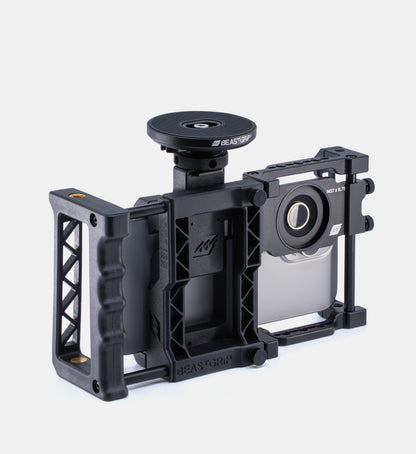 Studio shot of the Beastgrip Pro universal iPhone camera rig with MagSafe Magnetic Mount attached to the cold shoe mount on top