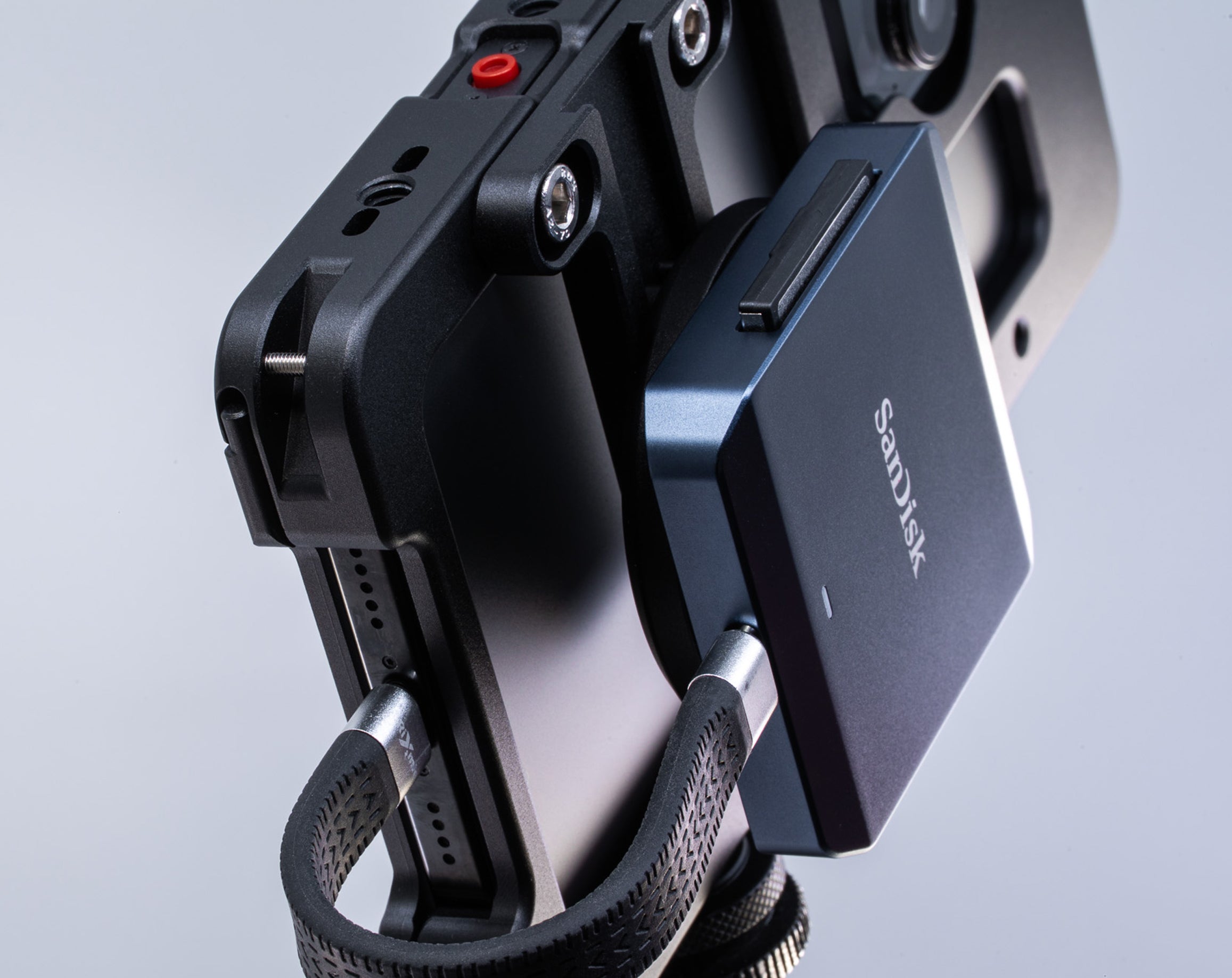 Close-up angled view of SanDisk CFexpress card reader with MagSafe attached to Beastgrip Magnetic Mount with T-Bracket on Beastcage for iPhone