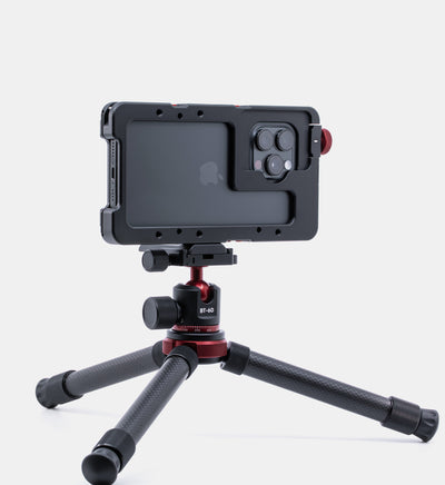 Beastgrip Quick Release Plate attached to Beastcage 16 Series, mounted on Beastgrip BT-60 mini tripod — compact and stable setup for mobile content creation.
